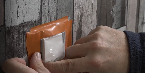 a person’s hand covering the switch with tape