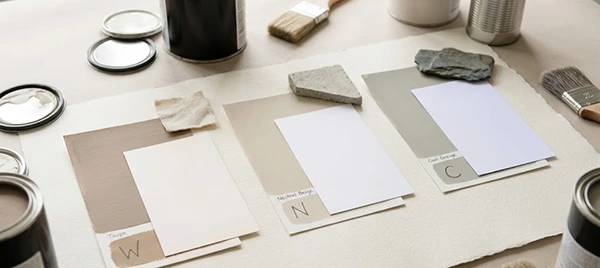 three different undertones of paper and sheets kept on the table with some paint boxes